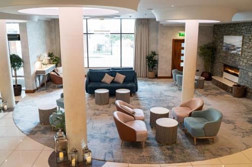 a lobby with couches and chairs and a fireplace at Trim Castle Hotel in Trim