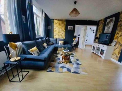 un salon avec un canapé bleu et une table dans l'établissement Domaine Les Tourelles 3, à Caffiers