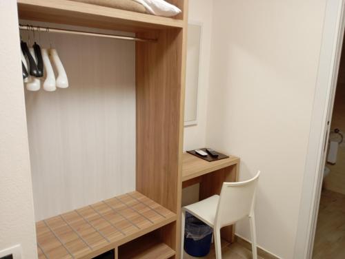 a small room with a desk and a chair at Hotel Meridiana in Arbus