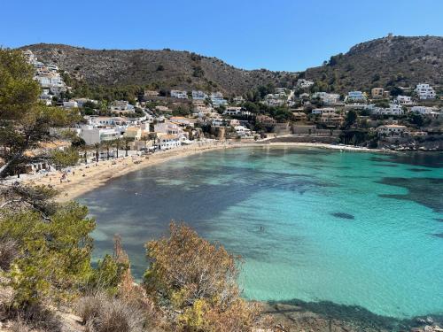 an aerial view of a beach with people in the water at Casa Nova, Moraira in Moraira