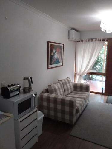 a living room with a couch and a tv at Hobreid Park in Woodend