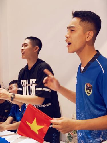 a group of young men holding a flag at City Hostel Da Nang in Da Nang