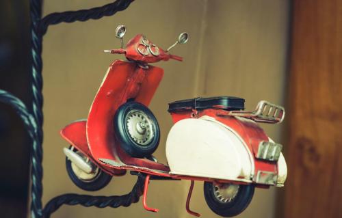 a figurine of a red and white scooter at Wilkamayu Hotel in Sicuani