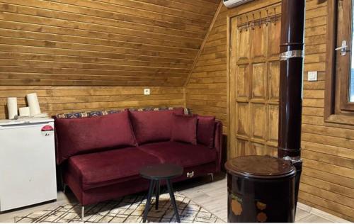 a living room with a red couch and a table at Cedrus life bungalov tesisi in Erdemli