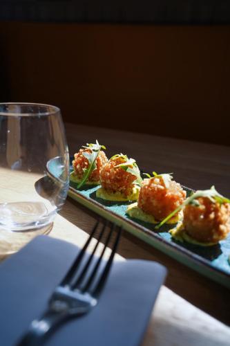 a plate of food on a table with a fork at PoMo Hôtel & Restaurant in Échirolles