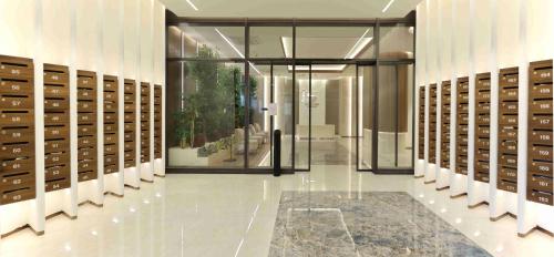 a large room with a door and a hallway with lockers at 180° View Apartment in Diamond Building Skopje in Skopje