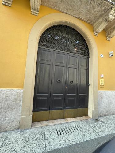 a large black door on the side of a building at Dimora Manin in Verona