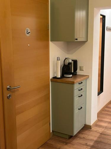 a kitchen with a door and a counter with a microwave at Charmantes Studio am Wörthersee in Reifnitz