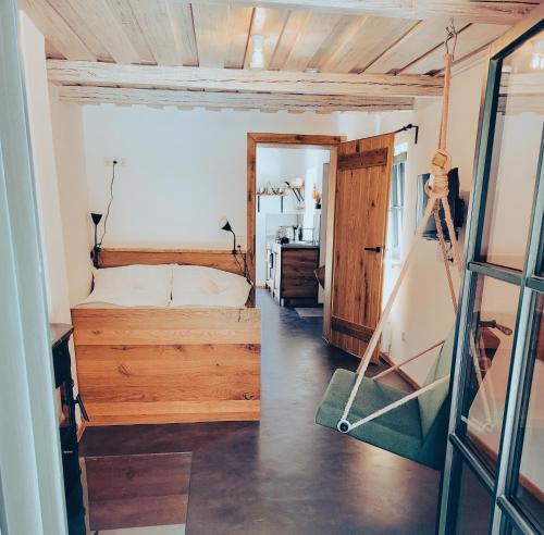 a bedroom with a bed and a room with a mirror at Kellerstöckl am Berg - Das Grüne in Steinbach