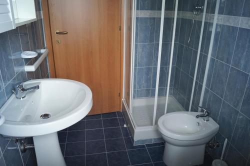 a bathroom with a sink and a toilet and a shower at Palazzina Cala Luna in San Benedetto del Tronto