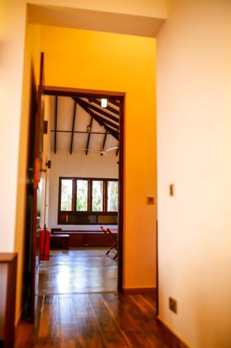 an open room with yellow walls and a living room at Nayan's Paradise in Kottanitivu