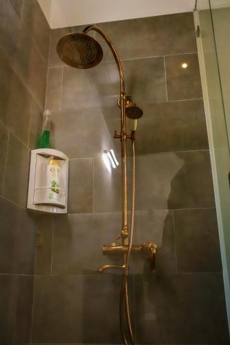 a shower with a shower head in a bathroom at Nayan's Paradise in Kottanitivu