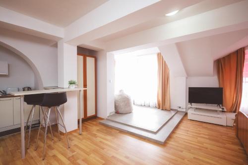 a kitchen and living room with a large window at AMMOTTI Hotel in Ohrid