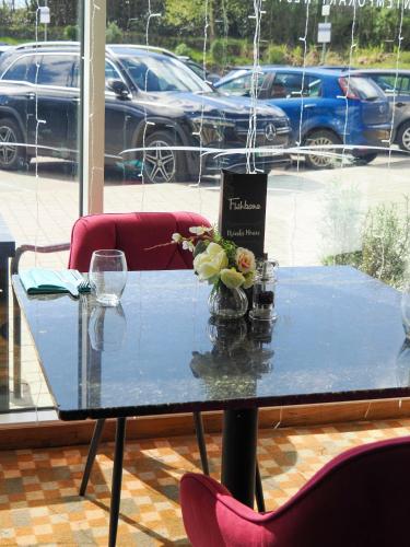a blue table with a vase of flowers on it at Future Inn Plymouth in Plymouth