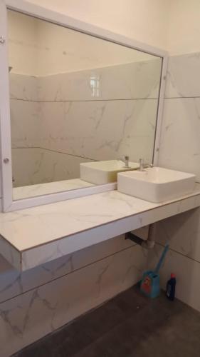 a bathroom with a sink and a mirror at TX property 11 in Gurgaon