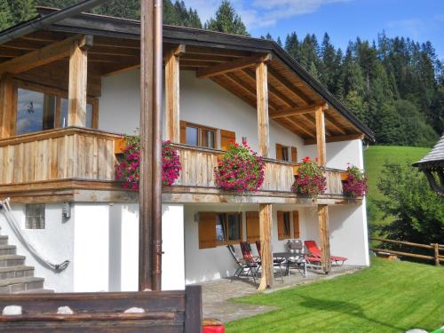 a house with a balcony with flowers on it at Chalet in Niederndorf near Kufstein with balcony in Niederndorferberg