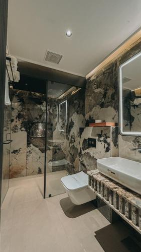 a bathroom with a toilet and a sink at Radhe Upavan Resort in Ahmedabad
