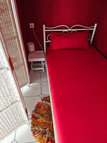 a bedroom with a red bed with a red pillow at Megi in Esslingen