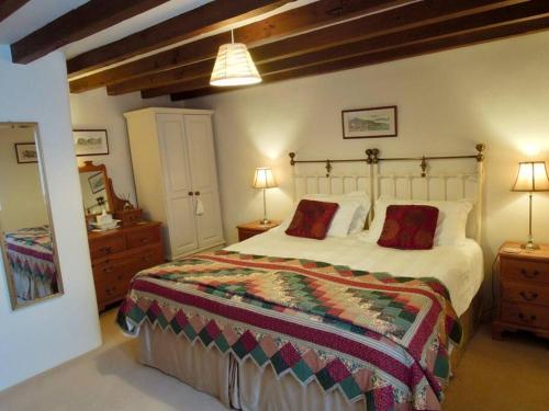 a bedroom with a large bed and two night stands at The Granary in St Austell