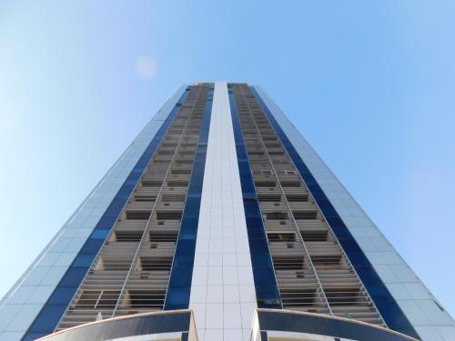a tall building with a blue sky in the background at CityView in Latina