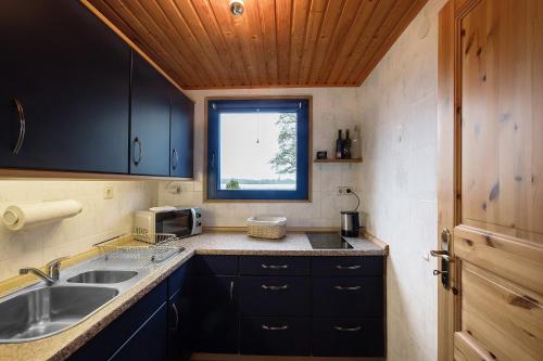 a small kitchen with a sink and a window at Ferienhaus 'am Seeufer' in Sietow