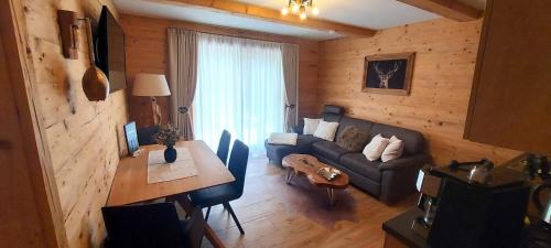 a living room with a couch and a table at Chalet Leßner in Leutasch