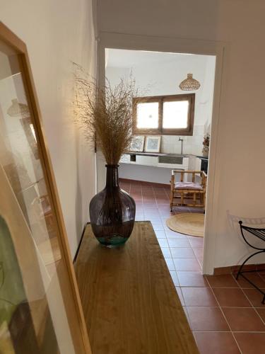 a vase sitting on a table in a living room at Casa Rural Cal Vellet del Priorat in La Vilella Baixa