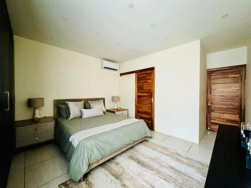 a bedroom with a large bed and a window at Charming 3 bedroom apartment with swimming pool in Flic-en-Flac