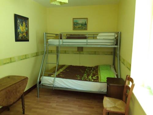 a bedroom with two bunk beds in a room at Charmante maison avec parc arboré près du Zoo de Beauval - FR-1-491-335 in Meusnes