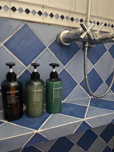 three bottles ofodorizers sitting on a bathroom counter at Casa Rural Cal Vellet del Priorat in La Vilella Baixa