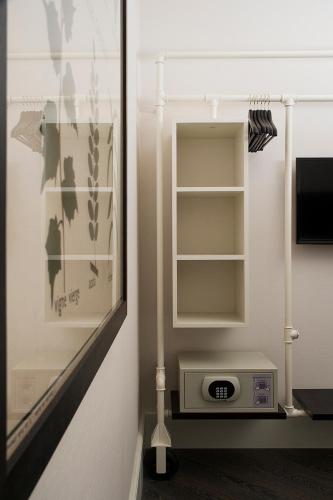 a room with a closet with a clock in it at Praktik Garden in Barcelona