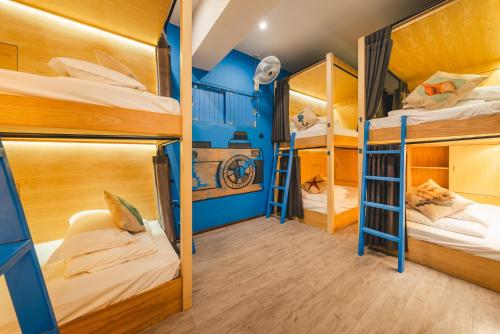 a room with bunk beds in a hostel at THALAY Cha-am by THA in Cha Am