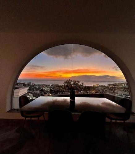 a view of a sunset through a window at Vila Ocean View Tenerife in Adeje