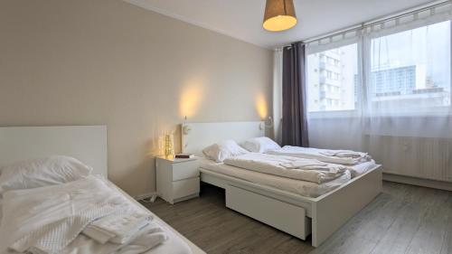 1 Schlafzimmer mit 2 Betten und einem Fenster in der Unterkunft GWG City Apartments III in Halle-Neustadt