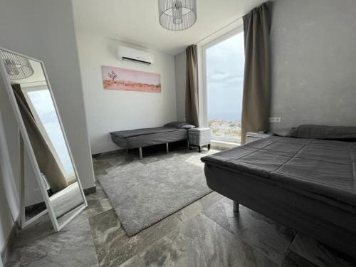 a bedroom with a bed and a large window at Vila Ocean View Tenerife in Adeje