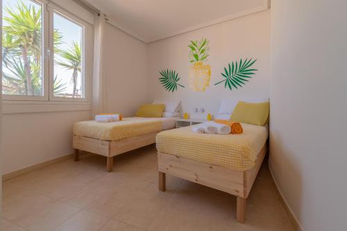 ein Schlafzimmer mit zwei Betten und einem Fenster in der Unterkunft Villa Piña in Corralejo