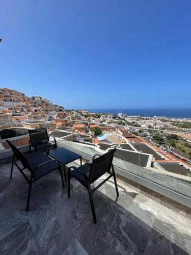 two chairs and a table on top of a roof at Vila Ocean View Tenerife in Adeje