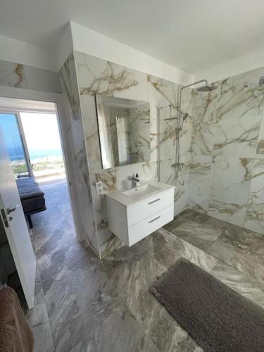 a bathroom with a sink and a mirror at Vila Ocean View Tenerife in Adeje