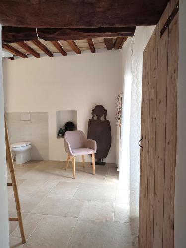 a room with a chair and a toilet at Ca' dei Giuli Apartments in Mercatello sul Metauro