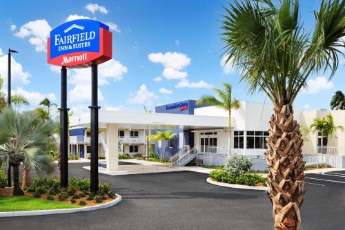 a hotel with a sign in front of a palm tree at Fairfield Inn & Suites by Marriott Key West at The Keys Collection in Key West