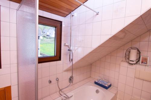 a bathroom with a shower and a bath tub at Bed & Breakfast Sandra Müller in Burg an der Mosel