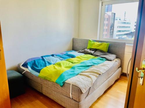 a bed sitting in a room with a window at Top Lage, Frankfurt Westend-Süd in Frankfurt