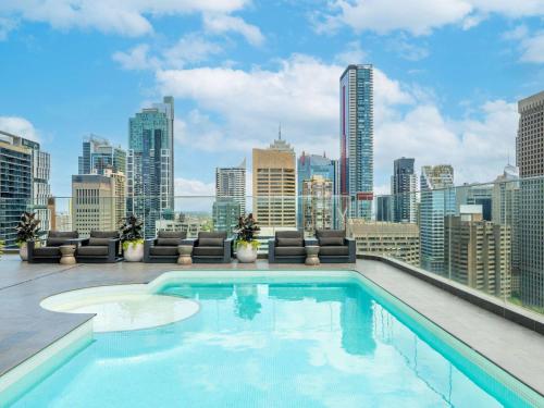 a swimming pool on the roof of a building at Pullman Sydney Hyde Park in Sydney