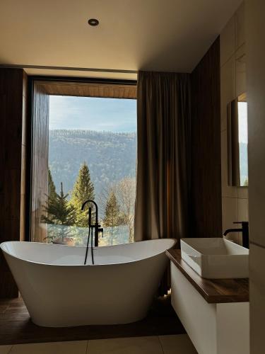 a bathroom with a tub and a large window at PROSTIR in Korostov