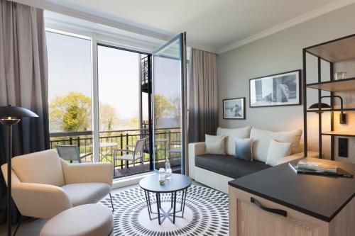 a living room with a couch and a table at Hotel Kaiserhof Heringsdorf in Heringsdorf