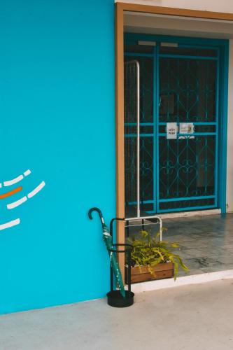 a bench in front of a building with a blue door at THALAY Cha-am by THA in Cha Am