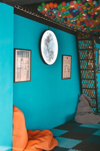 a room with a blue wall with a moon on it at THALAY Cha-am by THA in Cha Am