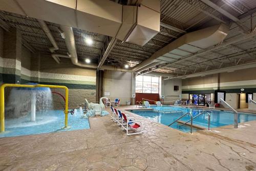 a large swimming pool with a water slide at Ramada by Wyndham Waupaca in Waupaca