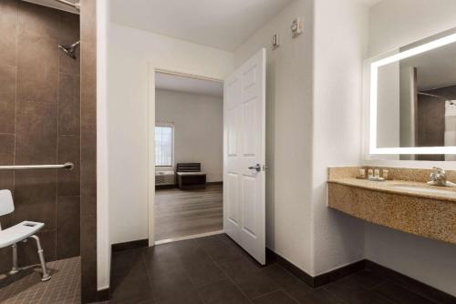 a bathroom with a sink and a mirror at La Quinta by Wyndham Port Arthur in Port Arthur