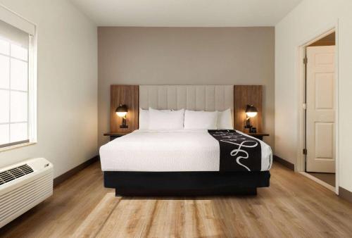 a bedroom with a large bed with white sheets and pillows at La Quinta by Wyndham Port Arthur in Port Arthur